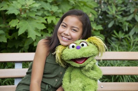Ten-year-old Salia Woodbury, whose parents are in recovery, with “Sesame Street” character Karli.