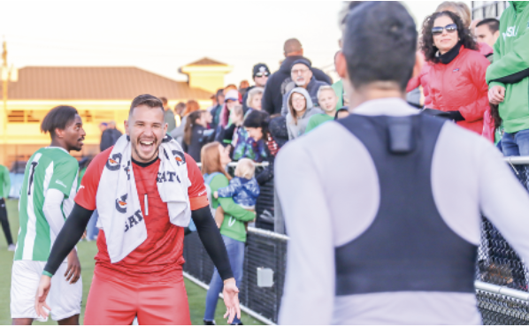 Paulo Pita (left) walks toward Pedro Dolabella (right) to embrace in a hug after their first win against Kentucky.