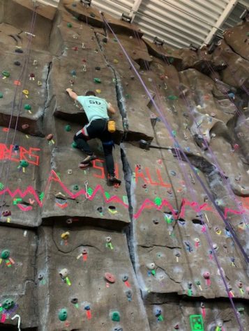 Rock wall gets neon makeover for climbing event at Marshall Rec Center