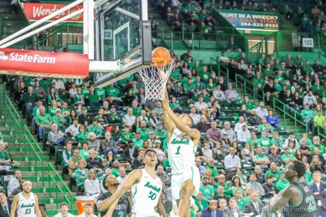Marshall basketball player Taevion Kinsey floats to the basket for a dunk.