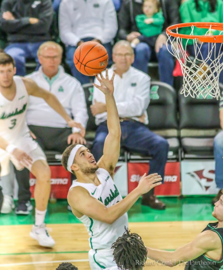 Junior guard Jarrod West floats the ball to the basket at the Cam Henderson Center.