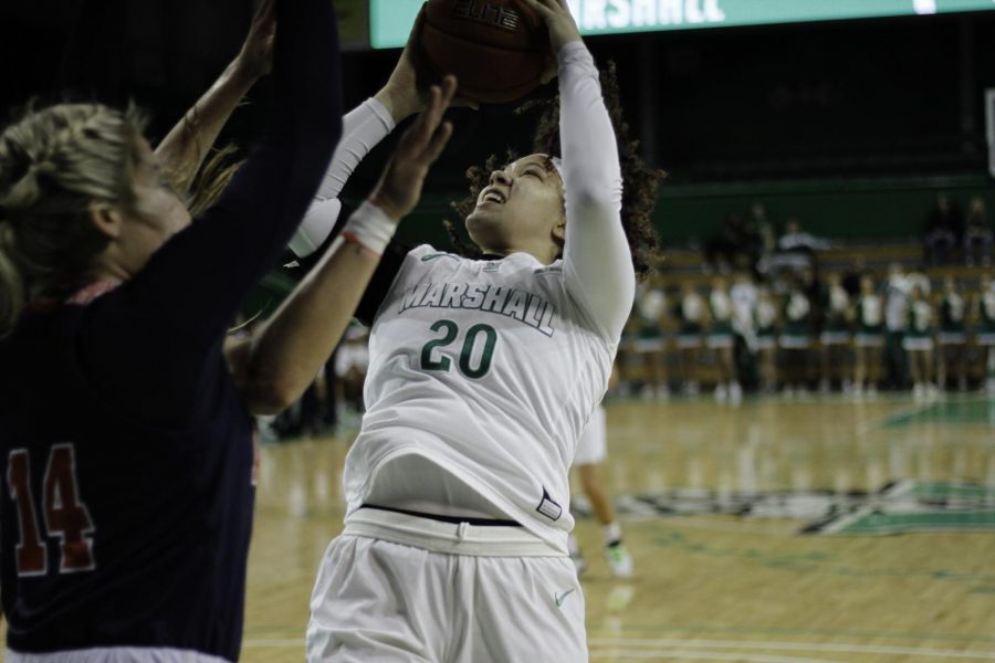 Junior Taylor Pearson put up a basket at the Cam Henderson Center.