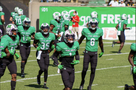 The Marshall University football team runs out onto the field before the Appalachain State game.