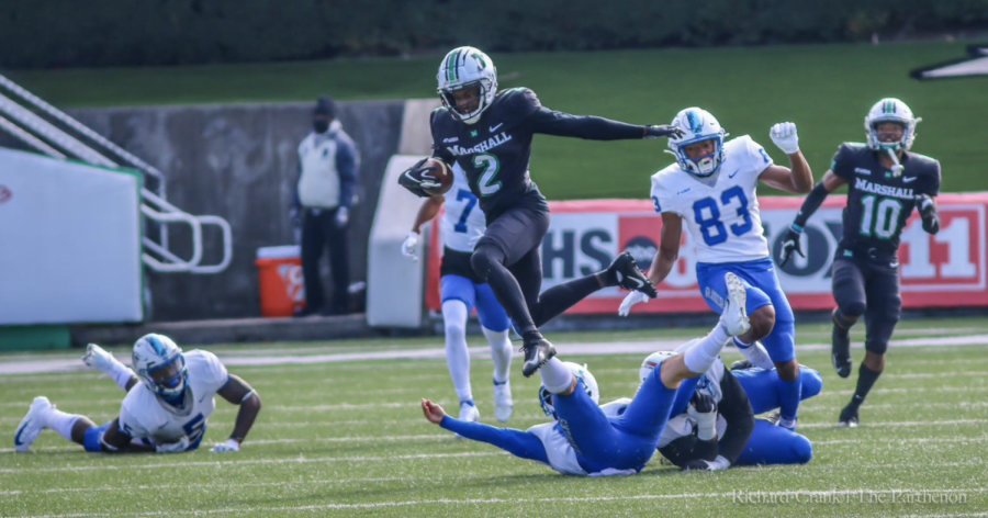 Marshall wide receiver Artie Henry jumped over Middle Tennessee State to avoid being tackled.