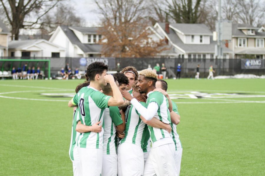 Members of the Marshall men’s soccer team huddle up during a match with Bowling Green on Feb. 27.