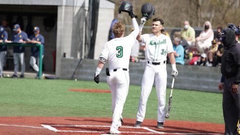 After his leadoff home run in the first inning, junior shortstop Geordon Blanton (3) is greeted at home plate by sophomore catcher Kyle Schaefer (34).