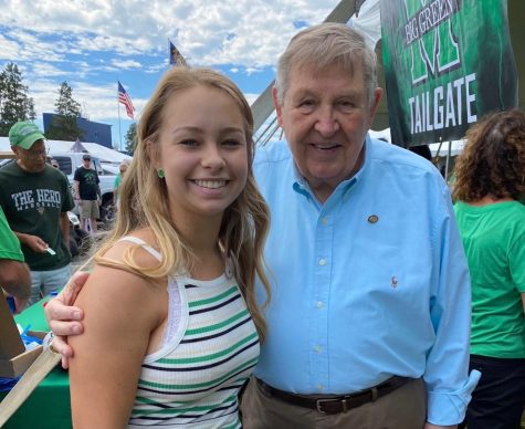 Student Body President, Alyssa Parks poses with notable alumni and former Navy coach Jack Lengyel at the Big Green Tailgate