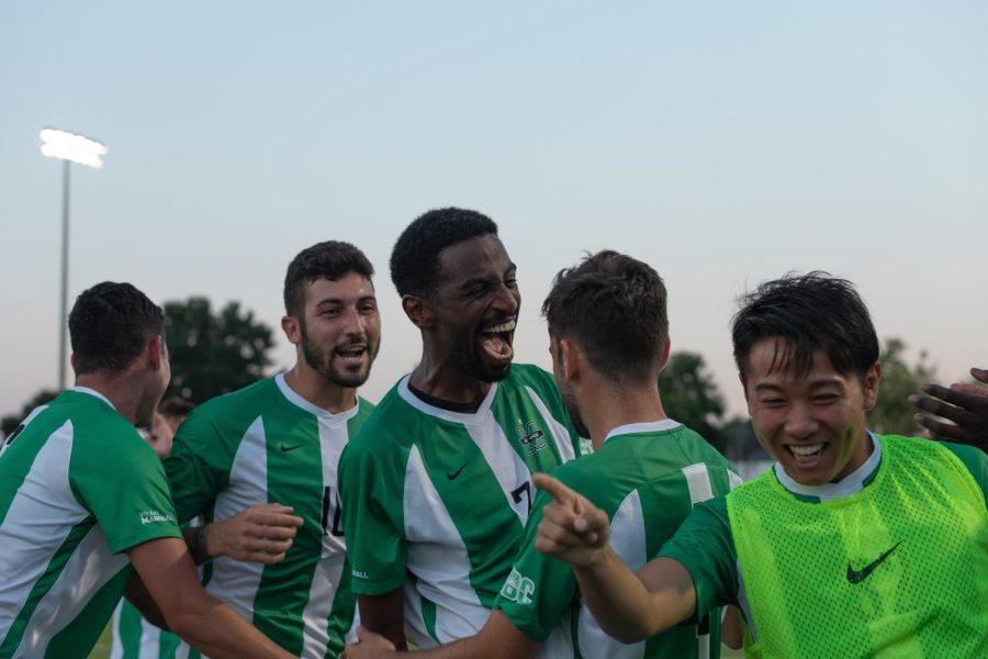 Milo Yosef celebrates with teammates after a goal.