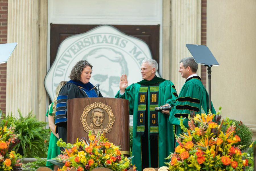 University president Brad D. Smith is sworn in by Sara Armstrong Tucker, chancellor of the WV higher education policy commission and chair of the Marshall University board of governors Patrick Farrell. 