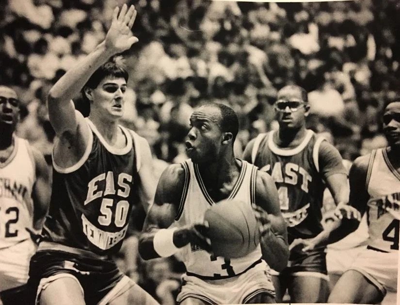 Skip Henderson playing basketball with the Marshall team during his academic career.