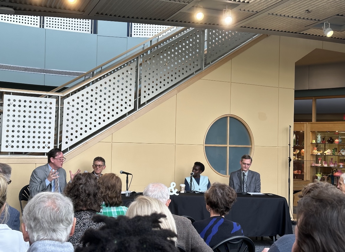 Panelists speak on distrust in science during a live podcast presentation.