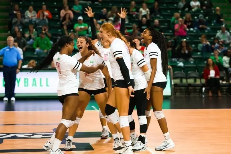 The volleyball team celebrates its victory against App State