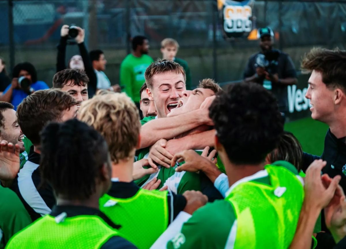 The Marshall Mens Soccer Team celebrates after a goal.