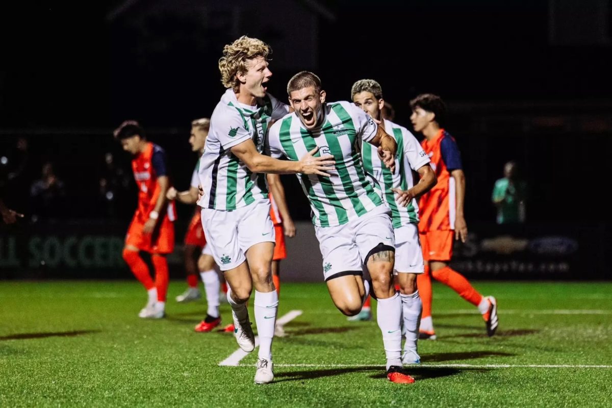 Vukovic celebrates with teammate Ryan Holmes.