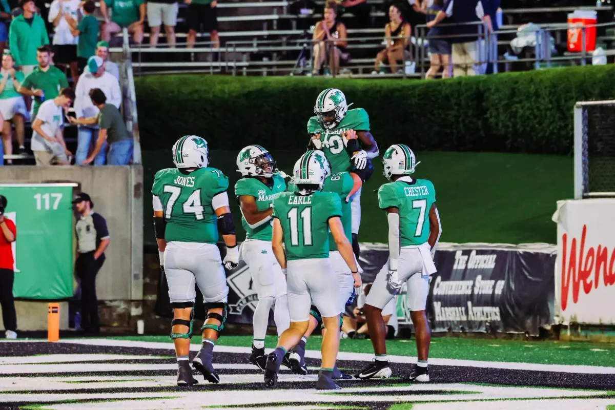 Marshall players celebrate in the end zone. 