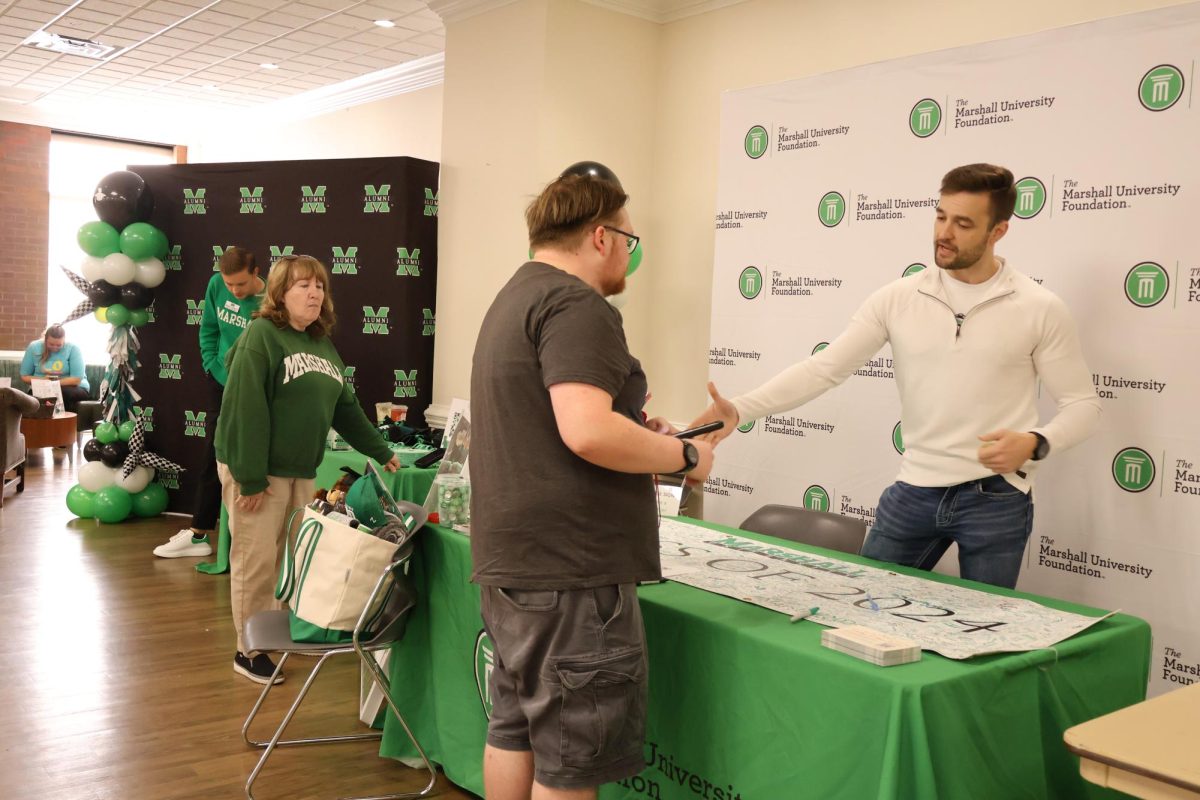 A student speaks with a Marshall Foundation representative during the Countdown to Commencement event.