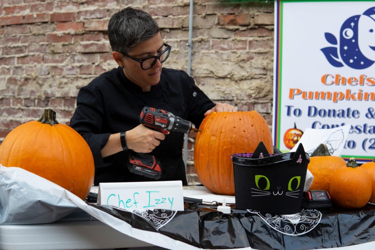 Chef Izzy, program director and head chef of Huntington's Kitchen assembling her pumpkin at a previous competition