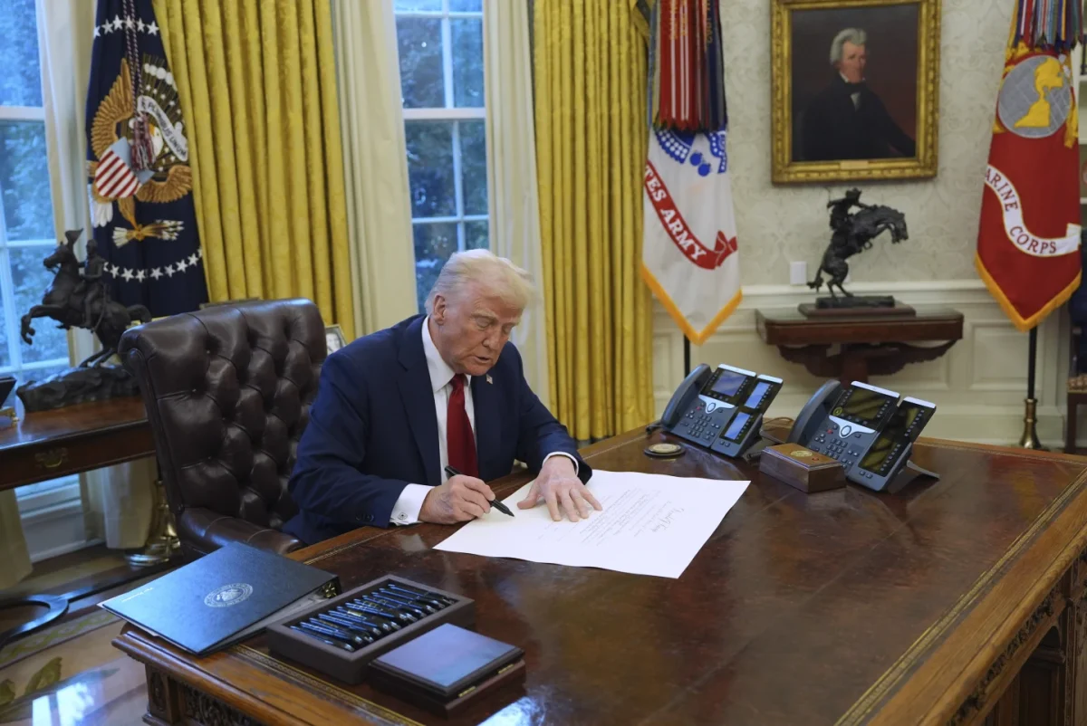 President Donald Trump signs executive orders in the Oval Office. 