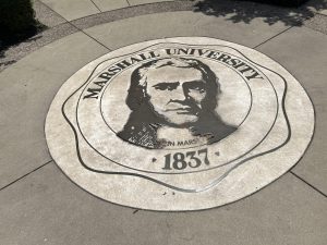 Official university seal featuring namesake John Marshall outside the Rec Center 