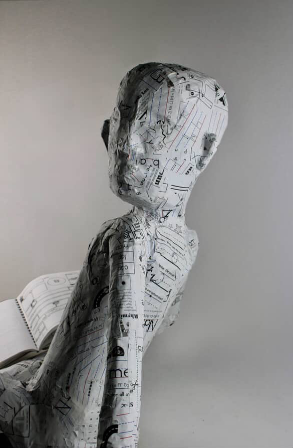 A figure sculpture made of recycled paper and an upcycled frame by Kal Anna