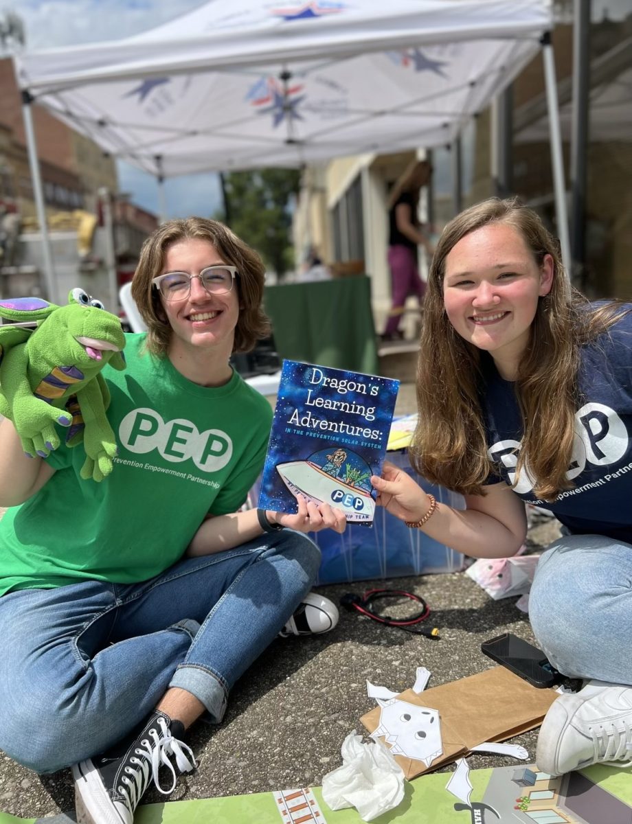 Brooklyn Johnson, right, is pictured with her children's book “Dragon’s Learning Adventures: In the Prevention Solar System." (Courtesy of Brooklyn Johnson)